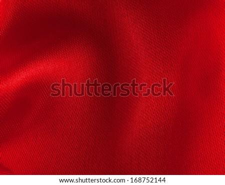 Red satin background in strict close up