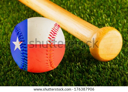 Baseball with Texas flag and bat over a background of green grass