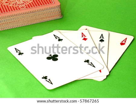 Four aces on the table, green background