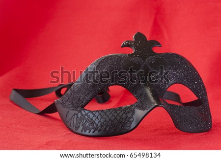 Black Carnival mask over a red background