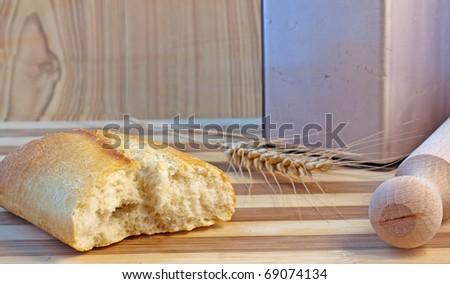 Cut bread, with ear of wheat, rolling pin and jar of flour