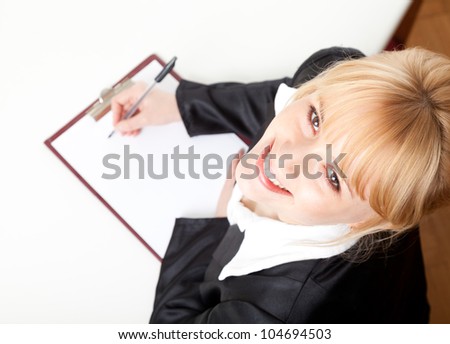 writing female student or businesswoman with clipboard, high angle view, white background