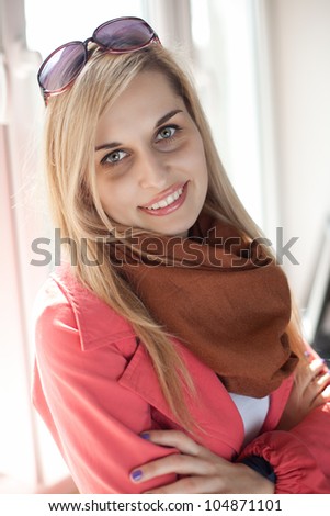 beautiful young woman with folded arms looking at the camera