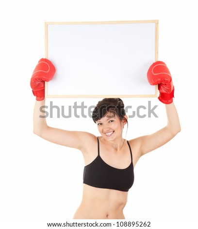 young woman wearing boxing gloves keeping blank poster over her head, white background