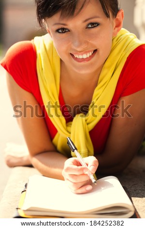 student young woman with notebook, outside