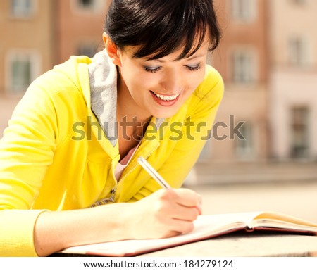 student young woman with notebook, outside