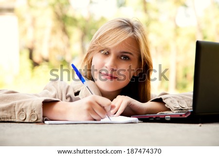 beautiful student girl with laptop in the park