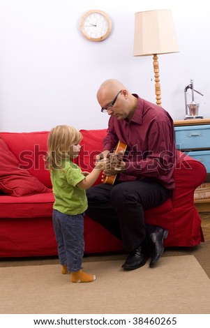 little girl with father play electric guitar