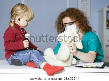 young girl in medical study studying plush rabbit