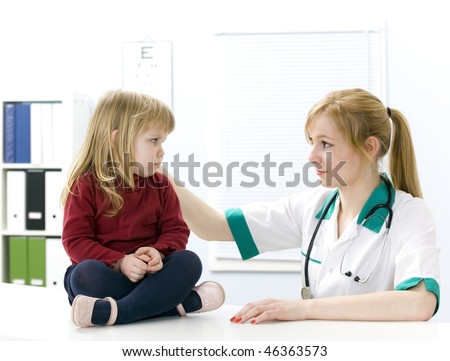 Young female doctor studies small sad girl