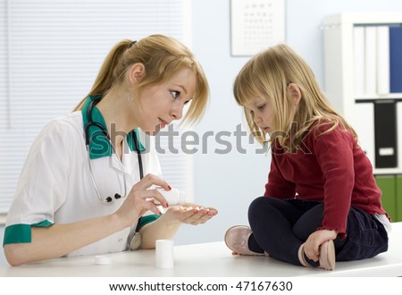 little girl at lady doctor looks at medicine