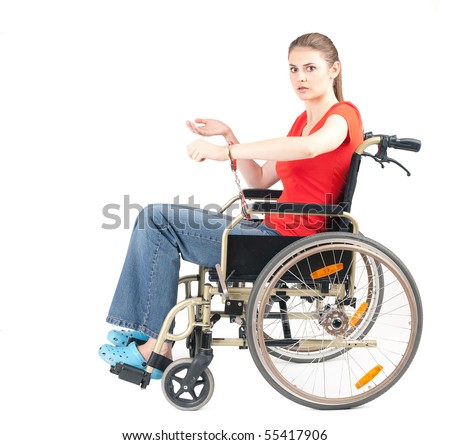 stock photo : terrified woman pinned to wheelchair by handcuffs