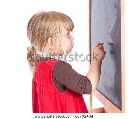 preschool girl in red dress drawing on blackboard