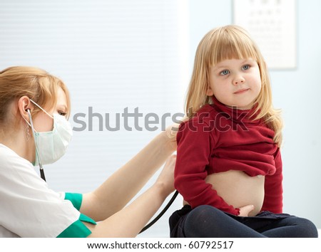 female doctor pediatrician examining  little girl by stethoscope