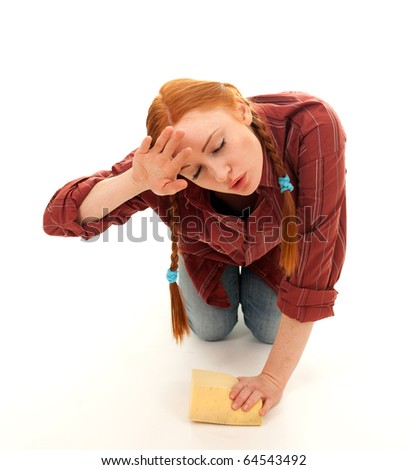 tired young woman washing floor by sponge