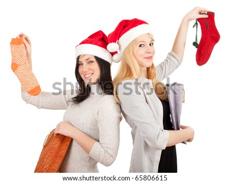 two young women in Santa hats with present bags and socks