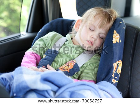 sleeping little, blond hair girl in car seat