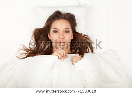 beautiful young woman in white bedding, keeping silence