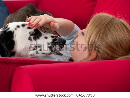 lying on red sofa young woman with dalmatian dog