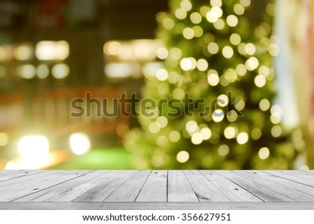rustic wood table in front of christmas light night,abstract circular bokeh background