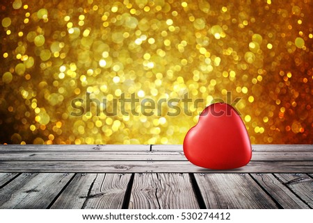 Red heart on wooden table with christmas gold light night,abstract circular bokeh background