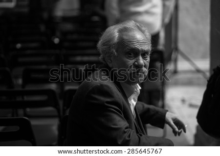 ROME, ITALY - MAY 21, 2013: The important Greek artist Jannis Kounellis standing waiting to talk in a conference ambiented in the beautiful \