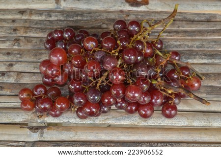red grape with water drops on bamboo background