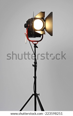 Black Movie Studio Light on a black stand isolated on gray background with real shadow