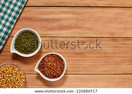 Corn Rice and Beans in a white Bowl on wood background with a Table Cloth. Healthy grain food selection with Text Space