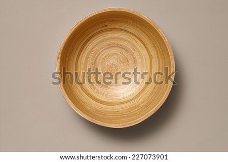 Empty Wooden Bamboo Bowl isolated on Grey Background with Real Shadow. Top View with Copy Space for Text