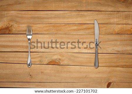 Fork and Knife on wooden background. Top View with Text Space