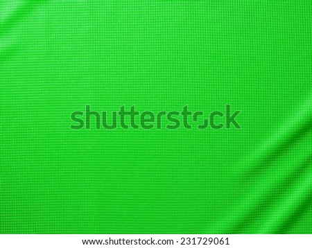 Sport Clothing Fabric Texture Background. Top View of Cloth Textile Surface. Green Football Shirt. Text Space