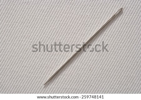 Sewing Needle on Cotton Fabric Background with Real Shadow. Top View with Copy Space for Text or Image