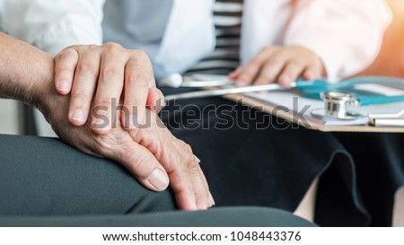 Geriatric doctor consulting and diagnostic examining elderly senior adult patient on aging, Parkinson\'s disease, Arthritis hand and knee pain and mental health care in medical exam clinic or hospital