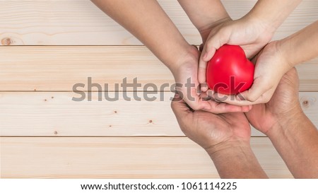 Life insurance, organ donor donation, give life charity and health assurance for family protection concept with father-mother parents and children supporting red heart together