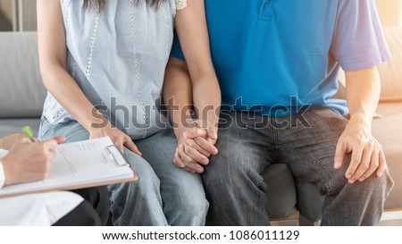 Patient couple having doctor or psychologist consulting on marriage counseling, family medical healthcare therapy, fertility treatment for infertility, or psychotherapy session concept