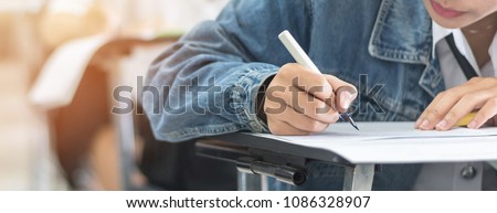 Exam with school student having a educational test, thinking hard, writing answer in classroom for  university education admission and world literacy day concept