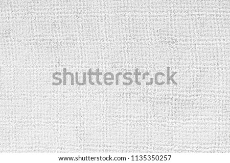 Carpet or white beach towel texture background in beige color made of wool or synthetic fibers, polypropylene, nylon or polyester material