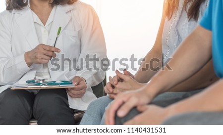 Doctor or psychologist with patient couple consulting on marriage counseling, family medical healthcare therapy, fertility treatment for infertility, or psychotherapy session concept