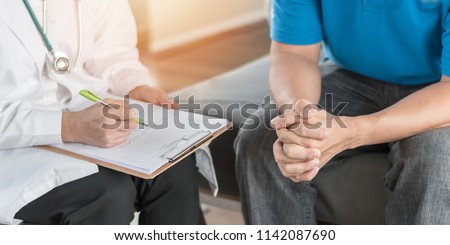 Male patient having consultation with doctor or psychiatrist who working on diagnostic examination on men\'s health disease or mental illness in medical clinic or hospital mental health service center