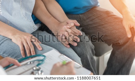 Patient couple consulting with doctor or psychologist on family men and women’s medical healthcare therapy, In vitro fertility IVF treatment for infertility, or STD sexual health concept