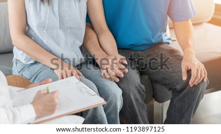 Patient couple consulting with doctor or psychologist on family men and women’s medical healthcare therapy, In vitro fertility IVF treatment for infertility, or STD sexual health concept