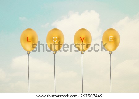 Love : text and letters on gold balloons made of golden eggs: Love sign on golden balloons with sky and clouds background in vintage style