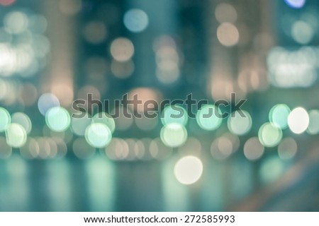 Blurred abstract background of Tokyo night lights on riverfront with water reflections and colourful bokeh in vintage style