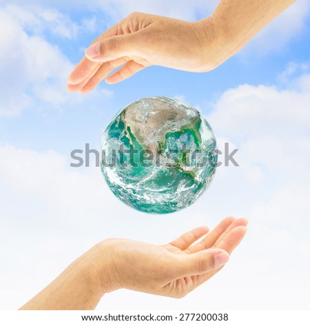 Green planet  between two people hands : Saving environment concept for world health : Green earth among two human hands : World environment day concept :  Elements of this image furnished by NASA.