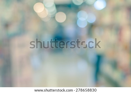 Blurred abstract background of people shopping in super market in vintage color tone : Shoppers in grocery store in a gangway : Walkway with full with goods and products on shelves in super market