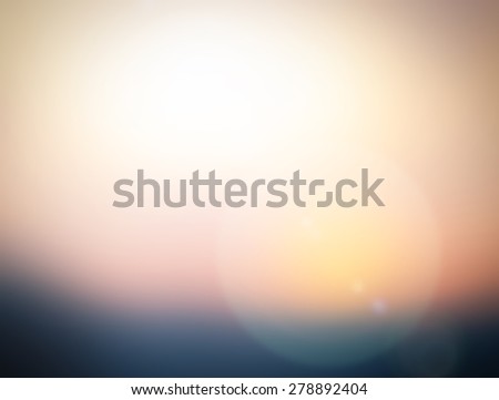 Blurred abstract background of morning light on the sky with bokeh and sun flare