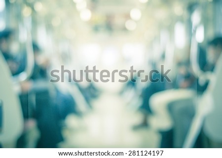 Blurred abstract background in vintage style turquoise color tone of people commuting on Tokyo subway train