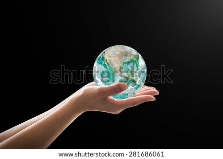 Isolated female human hands holding green planet on black background: Save the earth, preservation of environment and ozone layer concept: World peace idea: Elements of this image furnished by NASA