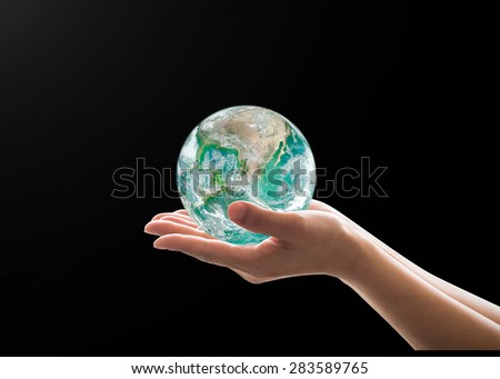 Isolated female human hands holding green planet on black background : World environment and hydrography concept: Pray for peaceful earth : Elements of this image furnished by NASA